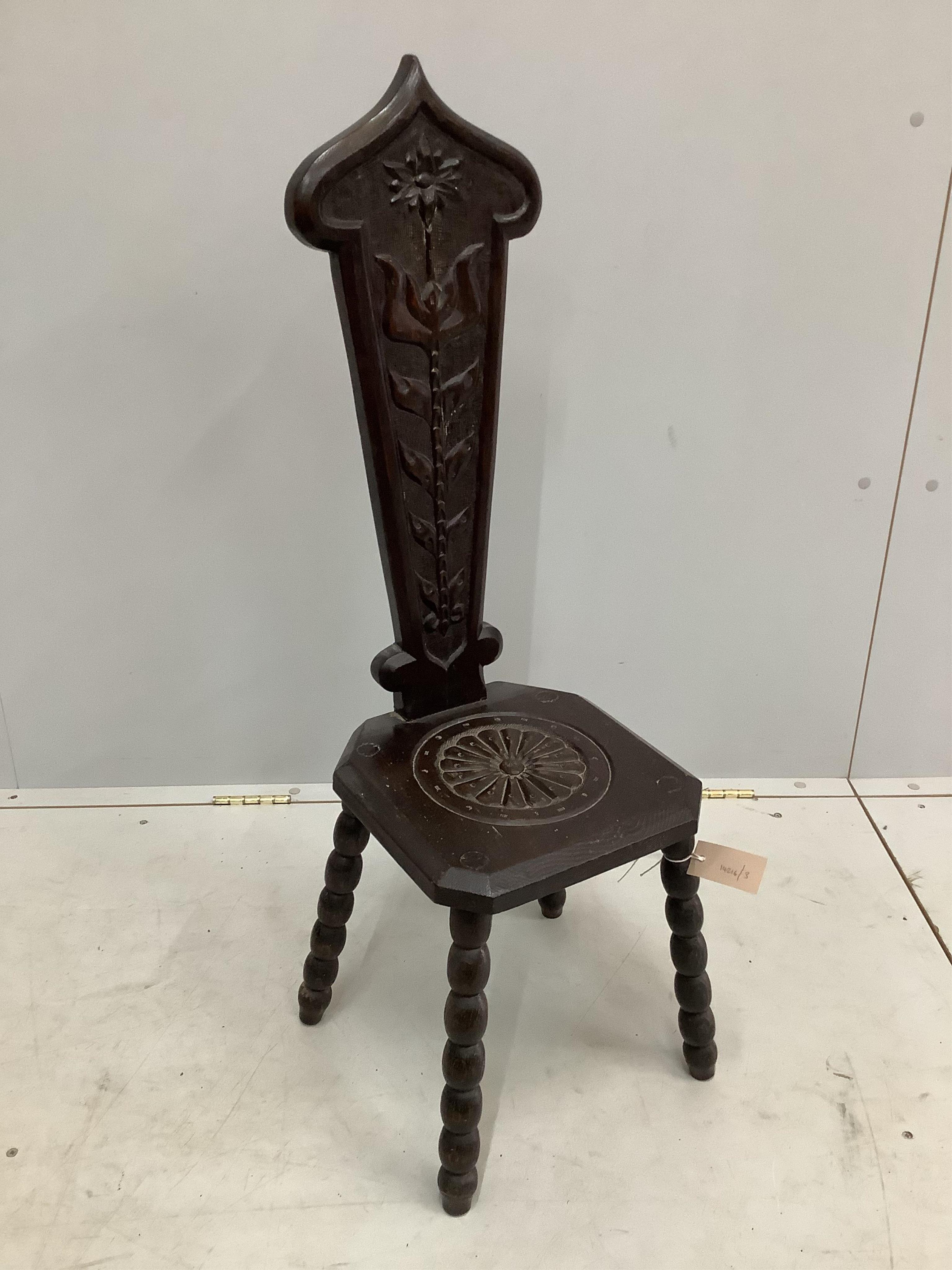 An early 20th century carved oak spinning chair, height 94cm